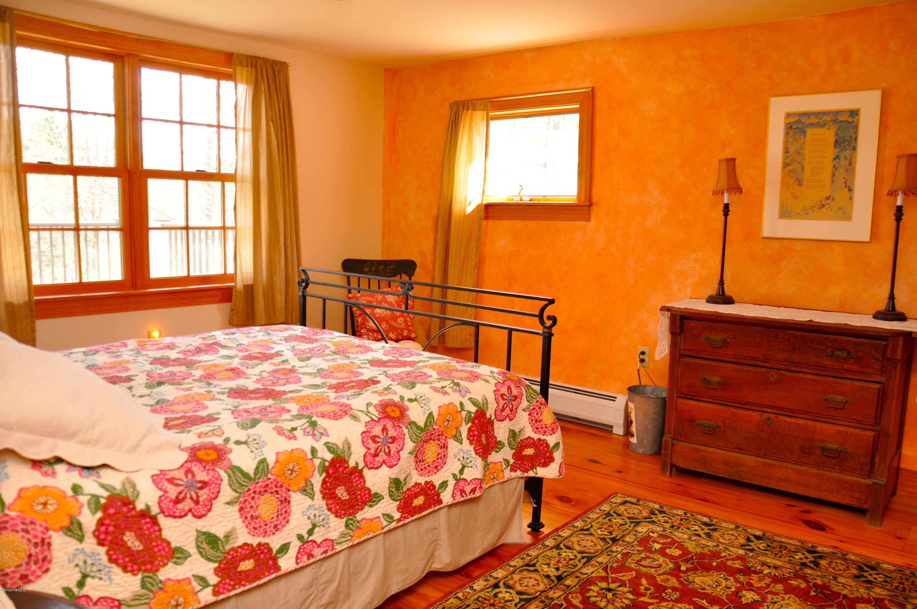210 Main Road Monterey, MA 01245 - Photo 13 of 33 a bedroom with a bed and wooden floor