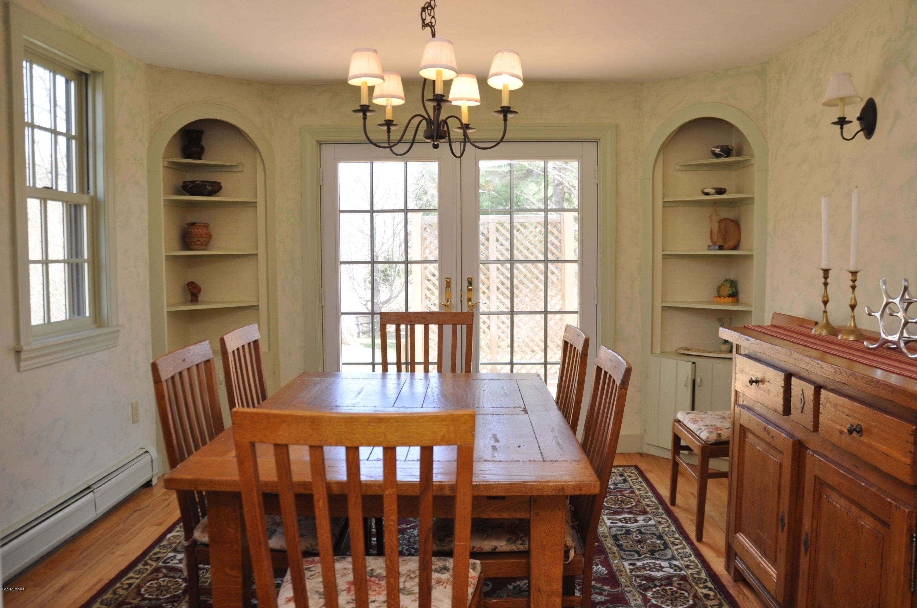 210 Main Road Monterey, MA 01245 - Photo 3 of 33 a view of a dining room with furniture a chandelier and wooden floor
