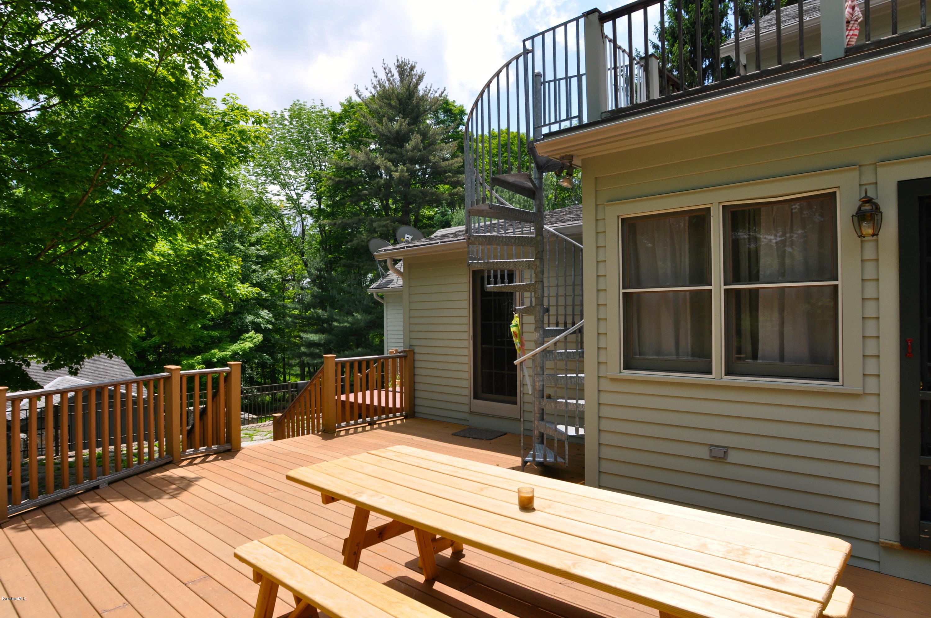210 Main Road Monterey, MA 01245 - Photo 25 of 33 a view of a house with a balcony and wooden fence