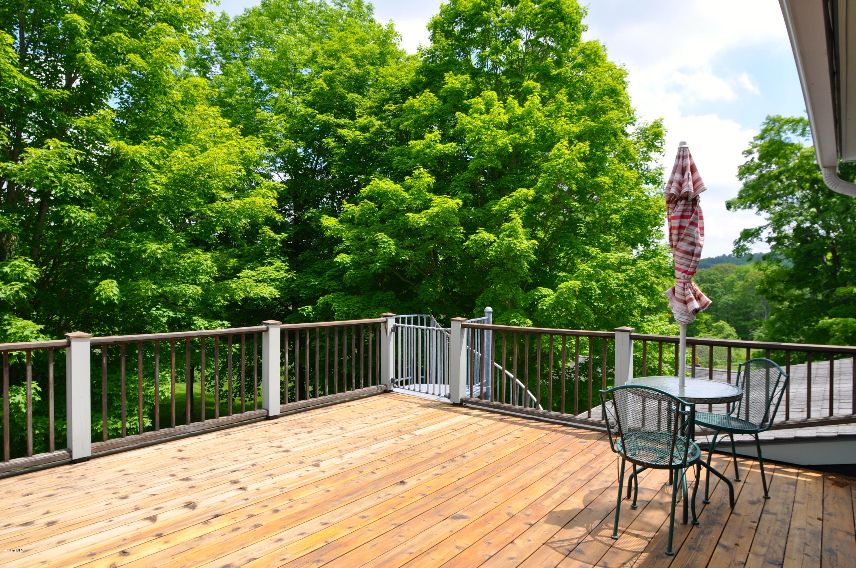 210 Main Road Monterey, MA 01245 - Photo 26 of 33 a deck with trees in front of it