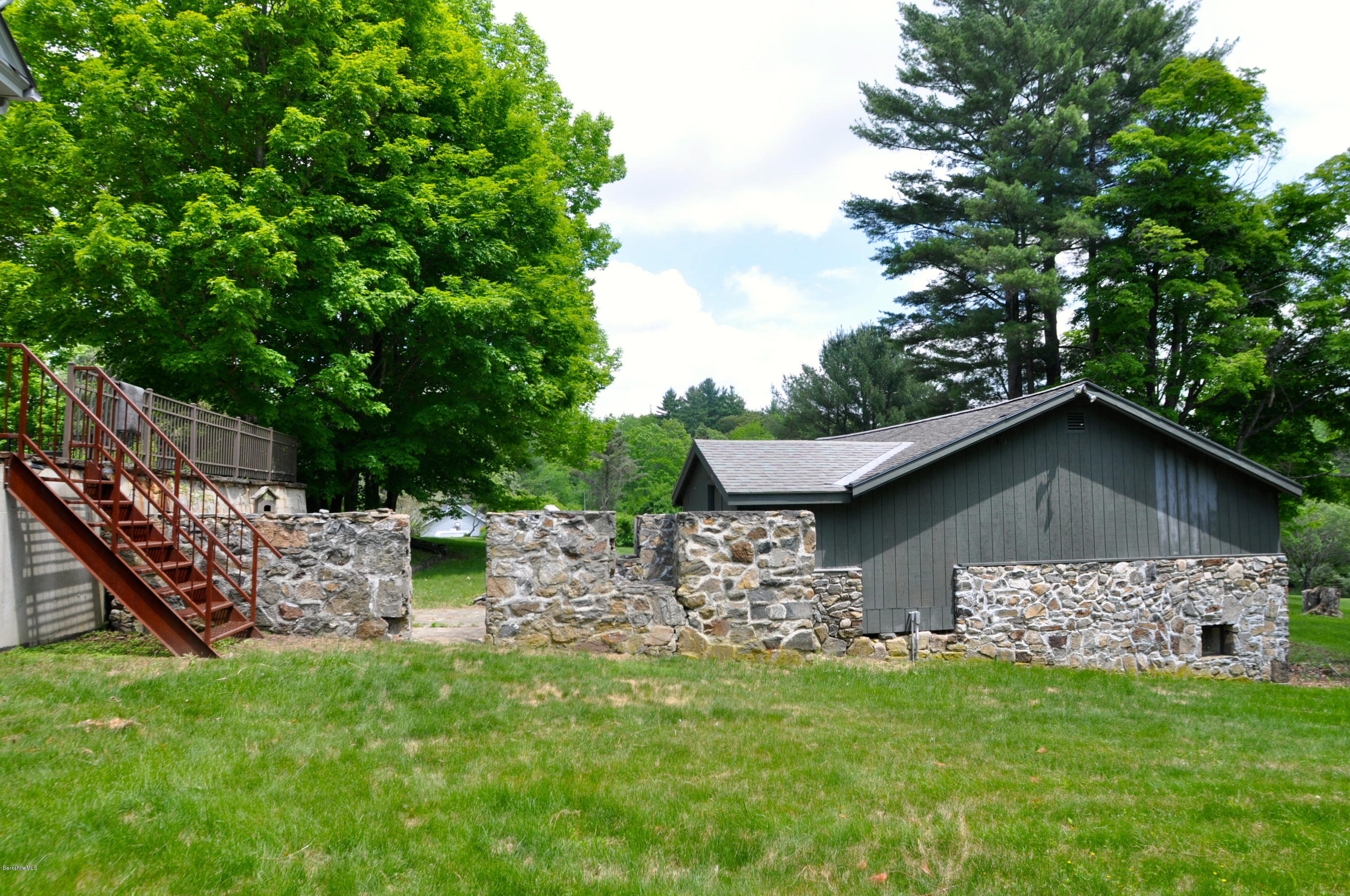 210 Main Road Monterey, MA 01245 - Photo 29 of 33 a front view of a house with a garden
