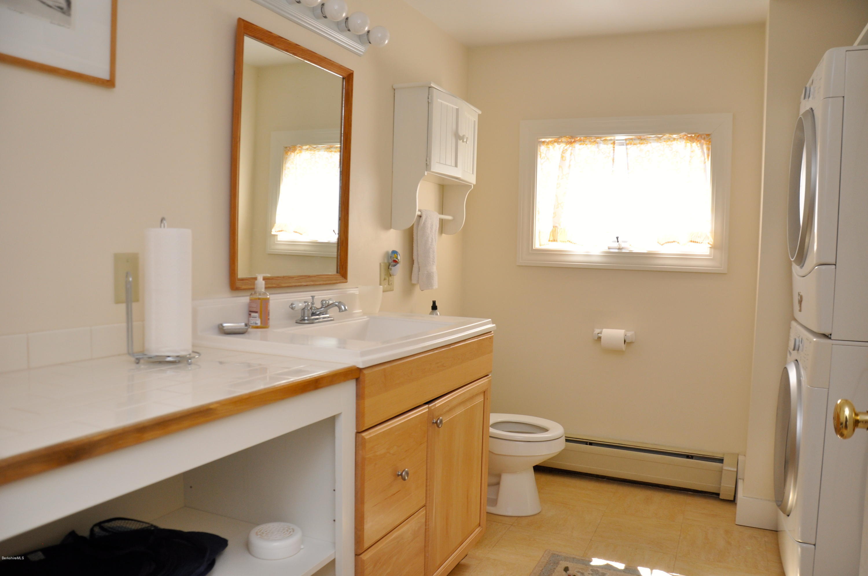210 Main Road Monterey, MA 01245 - Photo 8 of 33 a bathroom with a granite countertop sink toilet and mirror