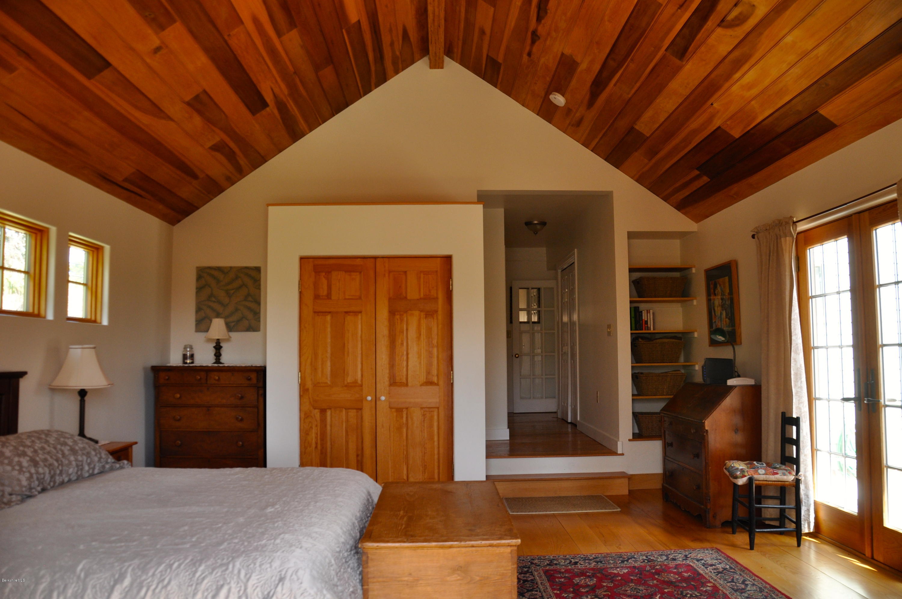 210 Main Road Monterey, MA 01245 - Photo 10 of 33 a bedroom with a bed and wooden floor