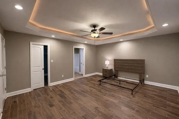 a bathroom with a granite countertop sink a toilet and a mirror