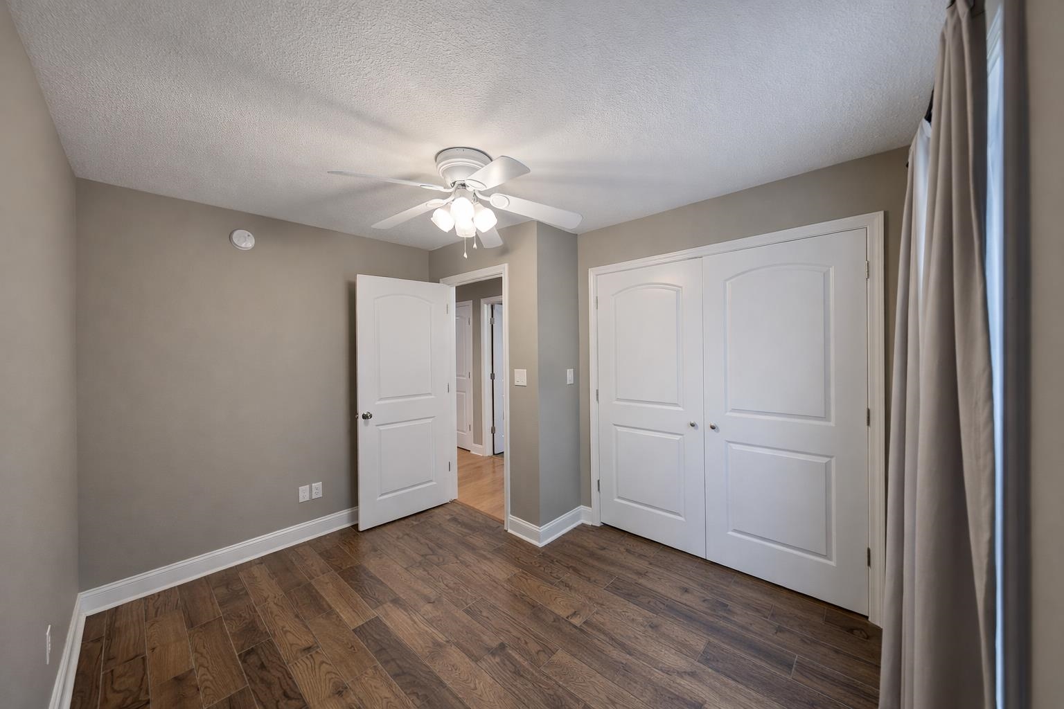 60 Masters Court Counce, TN 38326 - Photo 16 of 30 Unfurnished bedroom with dark wood finished floors, a textured ceiling, a closet, and ceiling fan