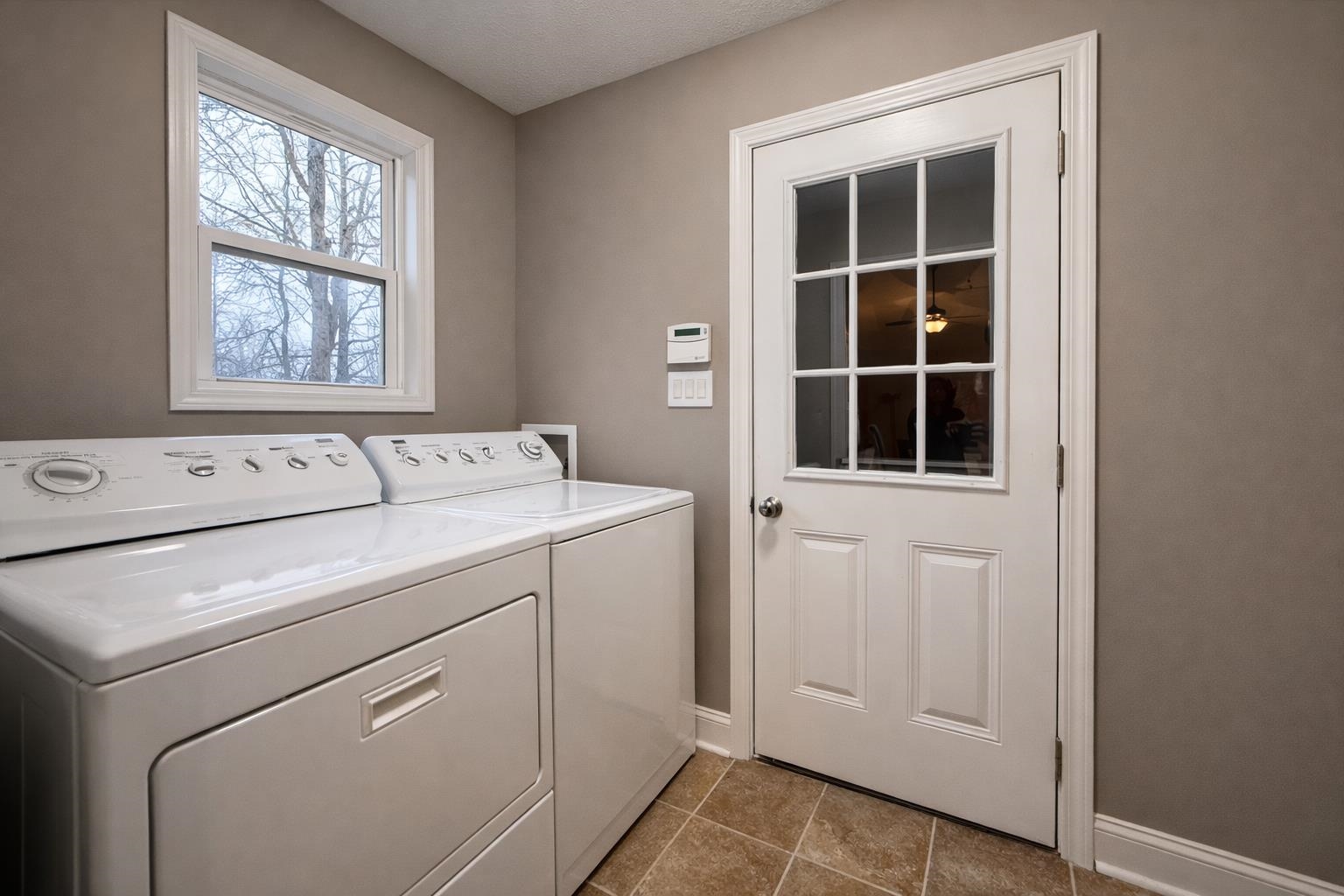 60 Masters Court Counce, TN 38326 - Photo 17 of 30 Laundry area featuring washer and dryer and dark tile patterned floors