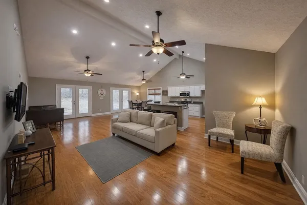 a living room with furniture or kitchen and a chandelier