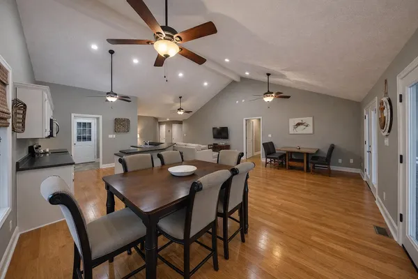 a dining room with furniture and wooden floor