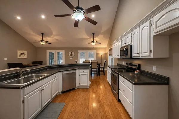 a kitchen with stainless steel appliances granite countertop a sink and stove top oven