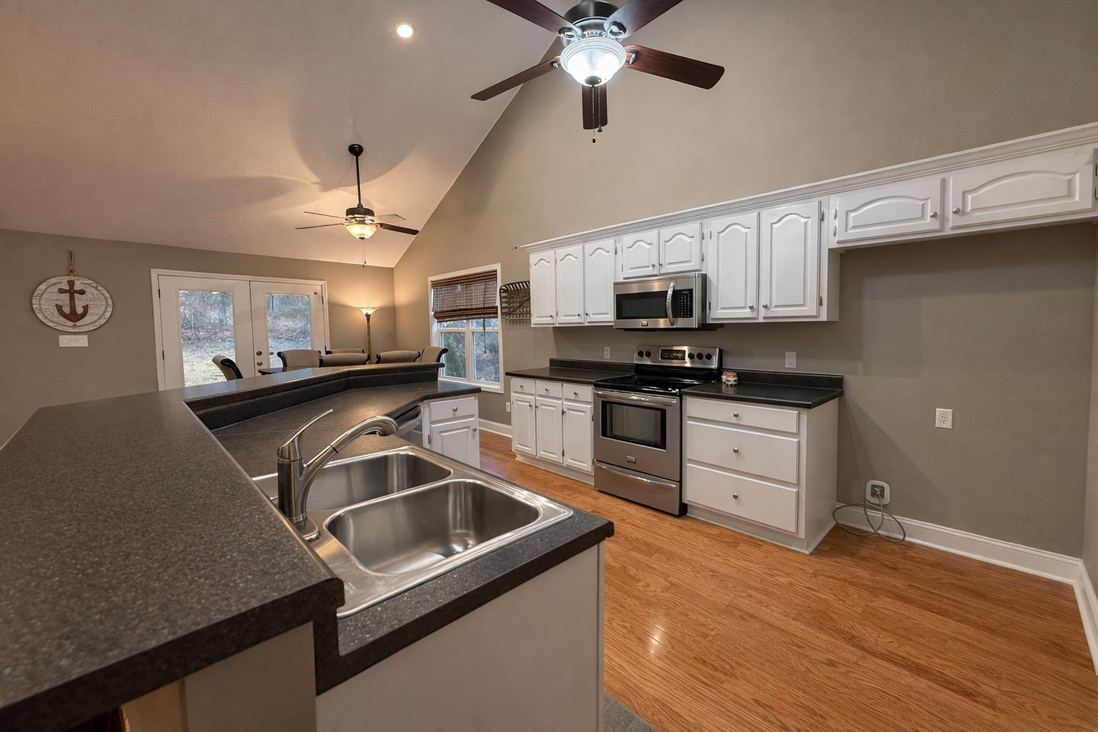 60 Masters Court Counce, TN 38326 - Photo 7 of 30 Kitchen featuring dark countertops, stainless steel appliances, white cabinetry, a ceiling fan, and vaulted ceiling