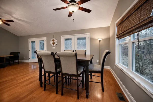 a living room with furniture gym equipment and a ceiling fan