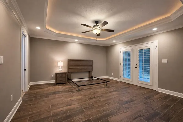 a living room with furniture gym equipment and a ceiling fan