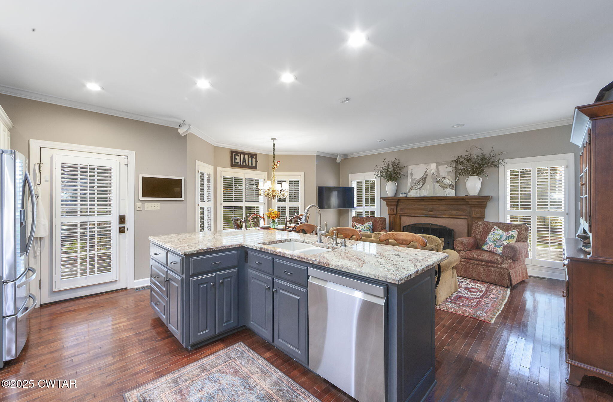 119 Bascom Road Jackson, TN 38305 - Photo 8 of 49 a kitchen with a stove a sink a refrigerator wooden floor and cabinets