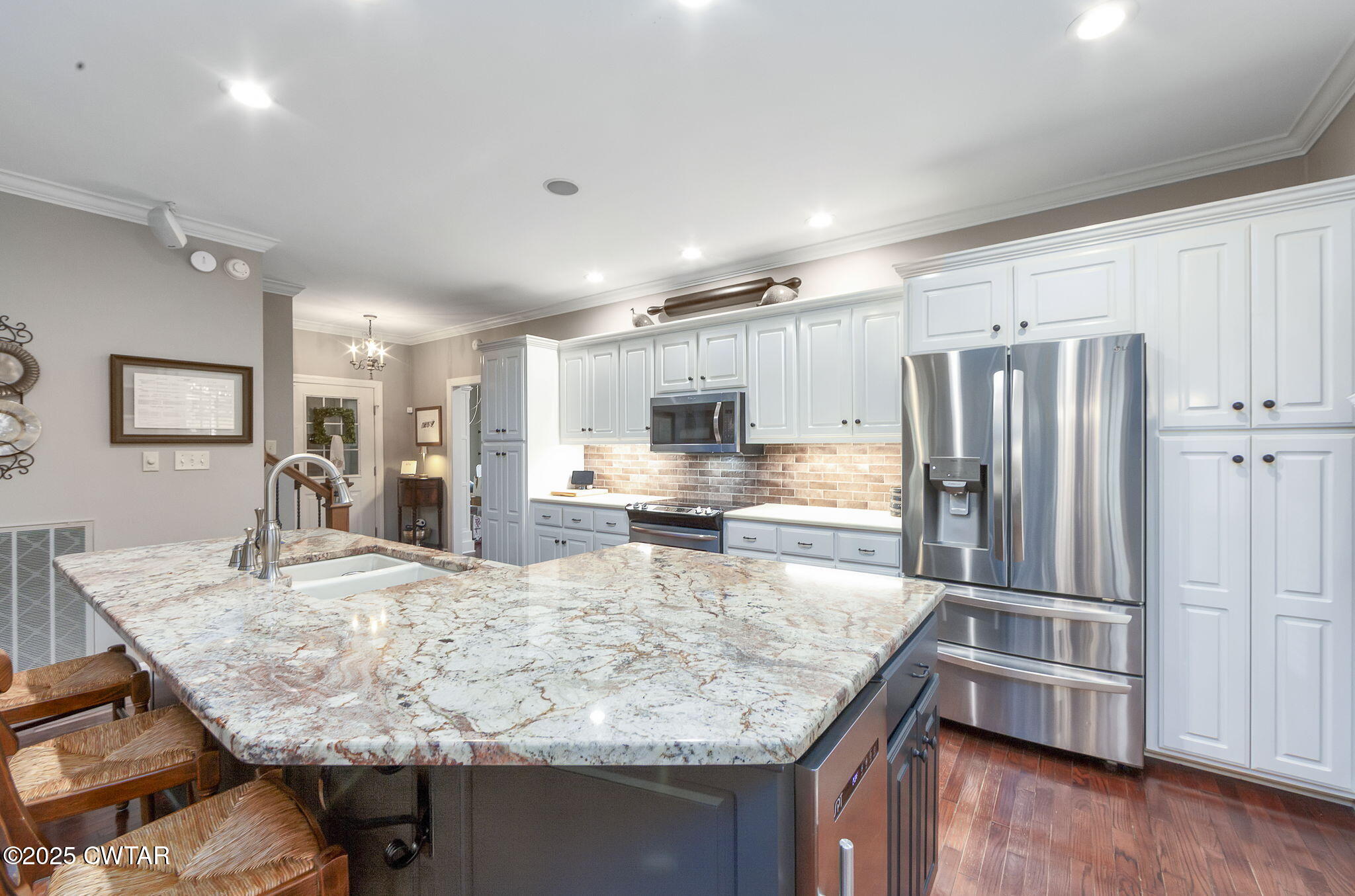 119 Bascom Road Jackson, TN 38305 - Photo 10 of 49 a kitchen with stainless steel appliances granite countertop a sink refrigerator and cabinets