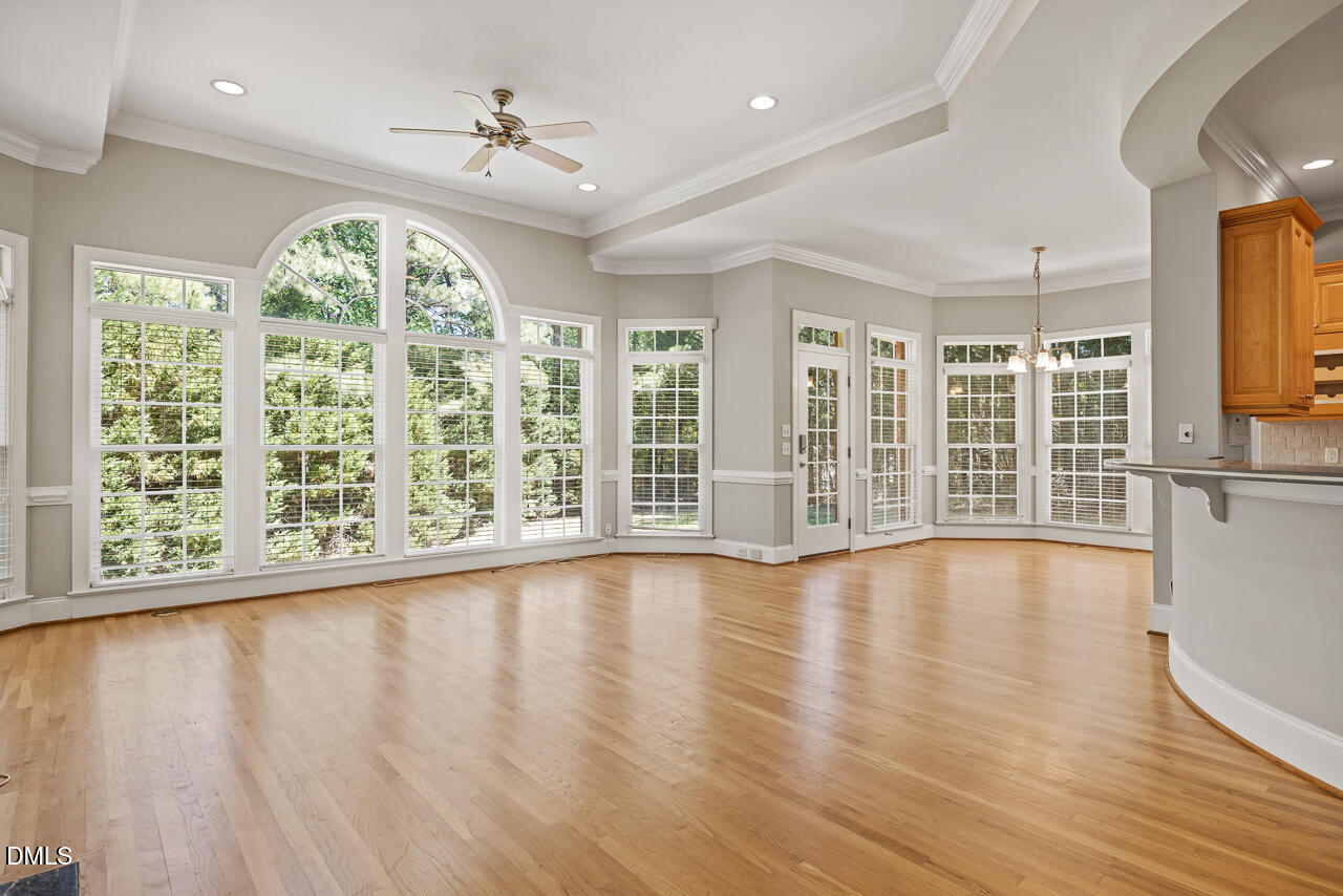 4004 Frontenac Court Apex, NC 27539 - Photo 14 of 61 a view of an empty room with wooden floor and a window