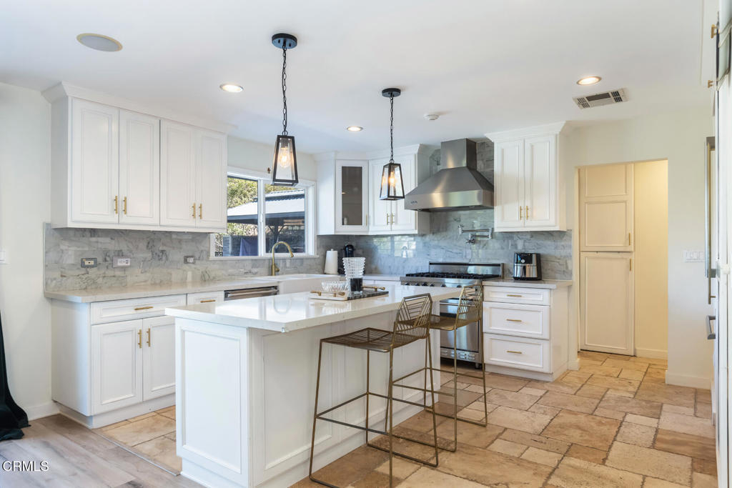 3623 St Elizabeth Road Glendale, CA 91206 - Photo 15 of 52 a kitchen that has a lot of white cabinets and stainless steel appliances