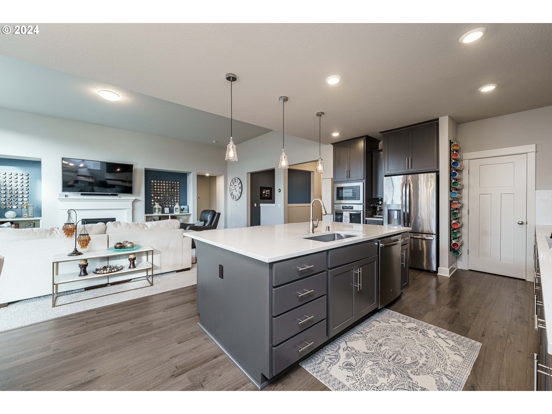 1839 South 47th Place Ridgefield, WA 98642 - Photo 23 of 40 a kitchen with stainless steel appliances kitchen island hardwood floor sink and stove