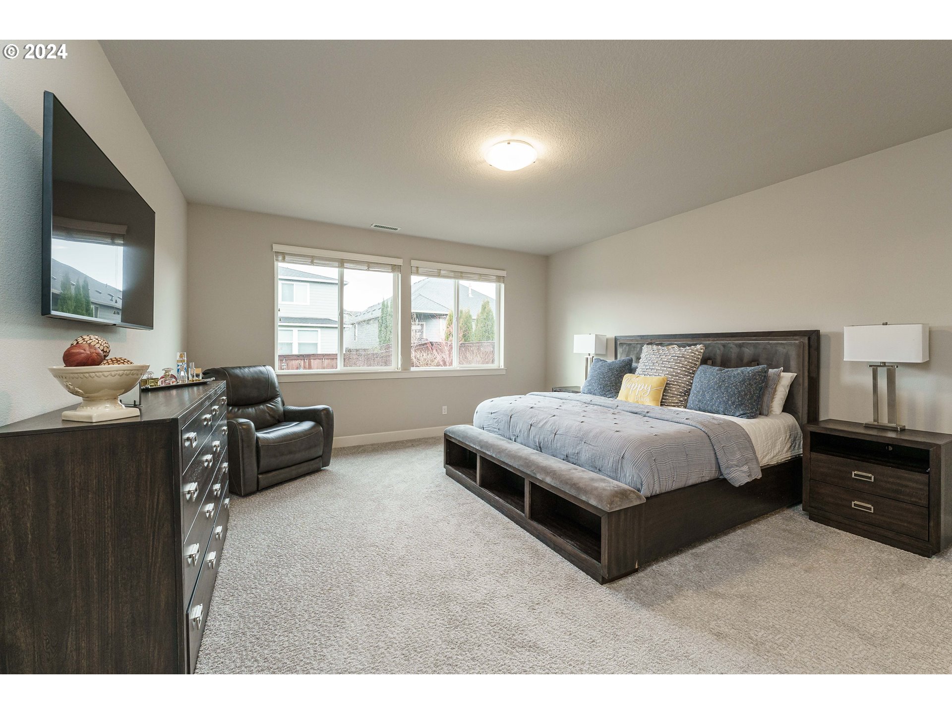 1839 South 47th Place Ridgefield, WA 98642 - Photo 28 of 40 a bedroom with a bed and a flat screen tv