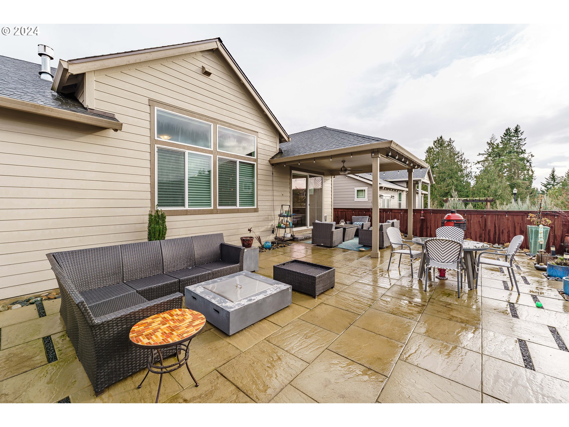 1839 South 47th Place Ridgefield, WA 98642 - Photo 34 of 40 a view of a patio with couches table and chairs under an umbrella