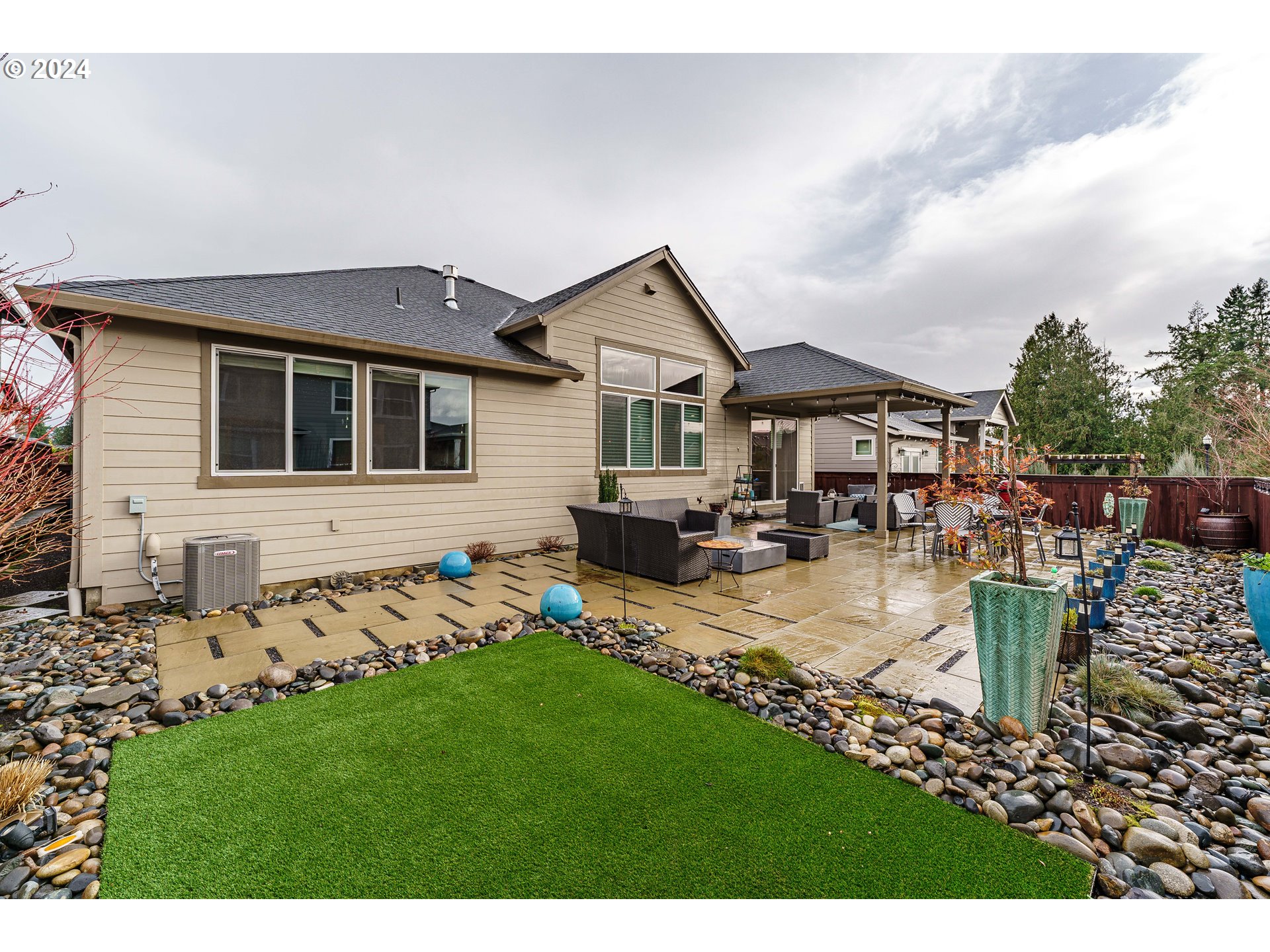 1839 South 47th Place Ridgefield, WA 98642 - Photo 35 of 40 a view of a house with a chairs in a patio