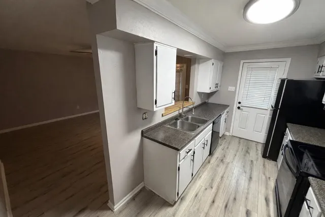 a kitchen with a sink stove and refrigerator