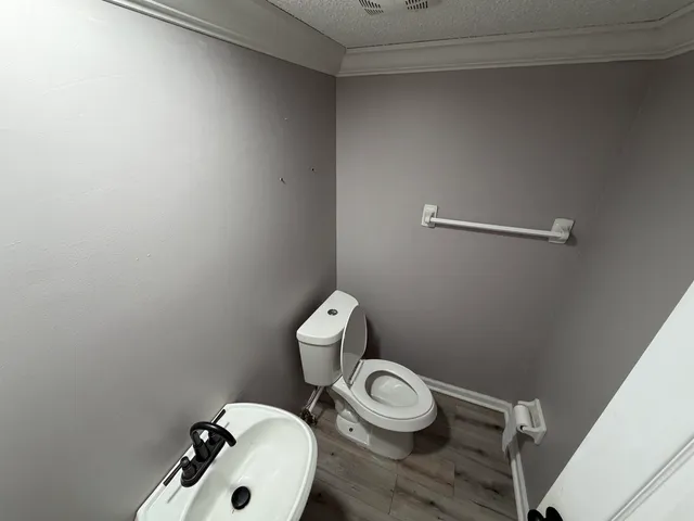 a view of hallway with wooden floor