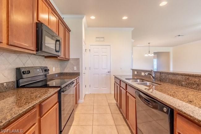 8887 Ravello Court Naples, FL 34114 - Photo 14 of 22 Kitchen featuring light tile patterned floors, sink, black appliances, an inviting chandelier, and light stone countertops
