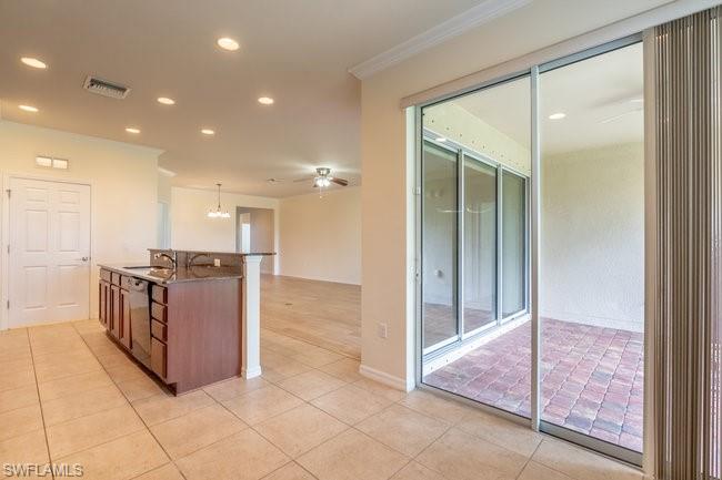 8887 Ravello Court Naples, FL 34114 - Photo 16 of 22 Kitchen with light tile patterned flooring, dishwasher, ceiling fan, decorative light fixtures, and ornamental molding