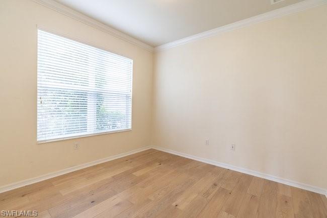 8887 Ravello Court Naples, FL 34114 - Photo 17 of 22 Unfurnished room featuring crown molding and light hardwood / wood-style floors