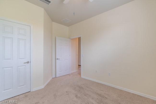 8887 Ravello Court Naples, FL 34114 - Photo 22 of 22 Unfurnished bedroom with ceiling fan and light colored carpet