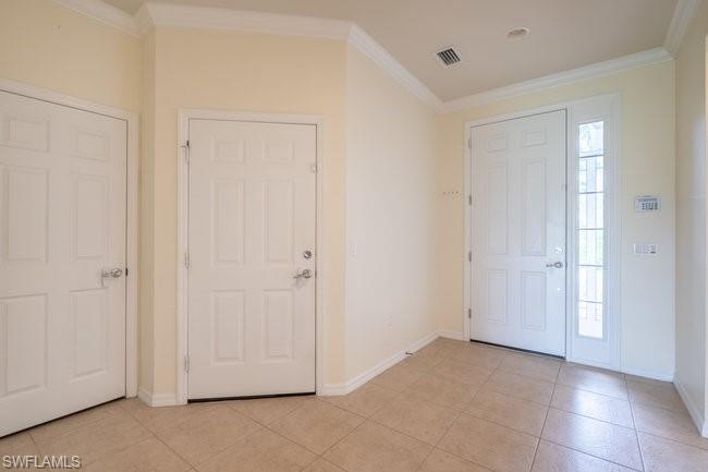 Tiled foyer entrance with ornamental molding