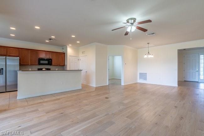 8887 Ravello Court Naples, FL 34114 - Photo 10 of 22 Kitchen featuring pendant lighting, light hardwood / wood-style flooring, stainless steel fridge with ice dispenser, a center island, and ceiling fan with notable chandelier