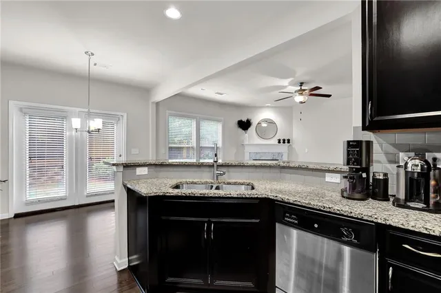 a living room with a fireplace windows and a fireplace