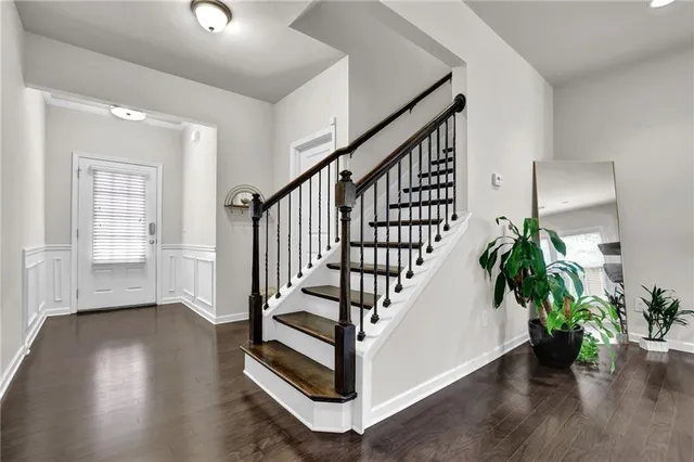a view of a livingroom with a ceiling fan and entryway