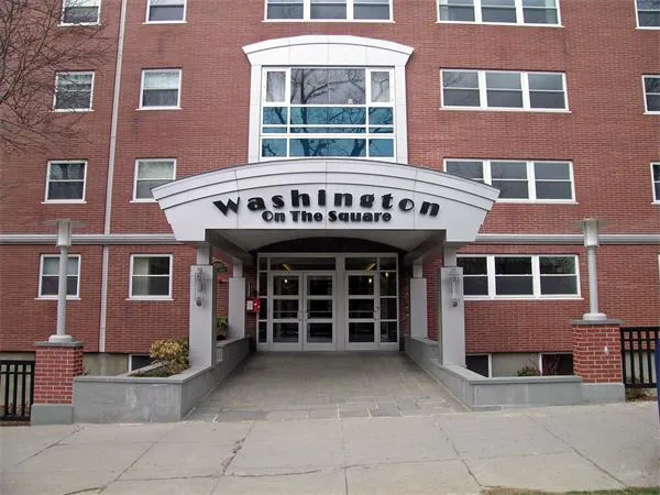 a view of a brick building with many windows