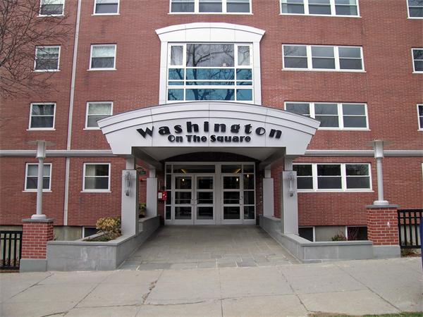 a view of a brick building with many windows