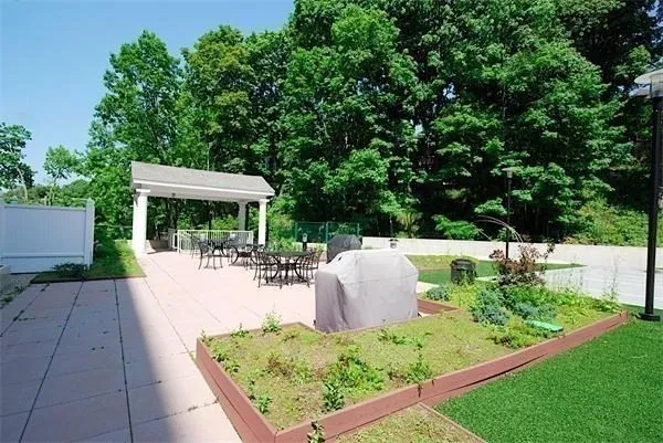 a view of backyard with seating space and green space