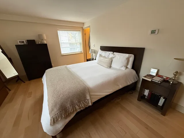 a bedroom with bed and window