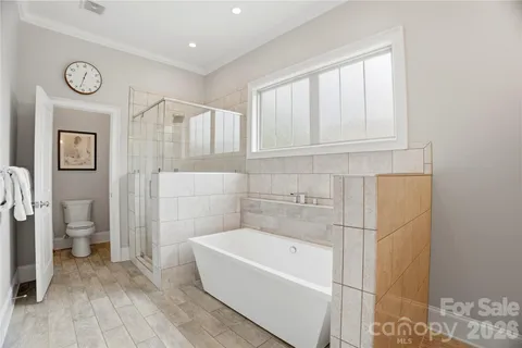 a bedroom with a bed and a ceiling fan