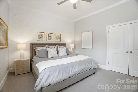 a bedroom with a large bed and a window