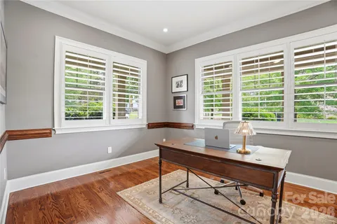 a kitchen with stainless steel appliances kitchen island granite countertop a table chairs and a refrigerator