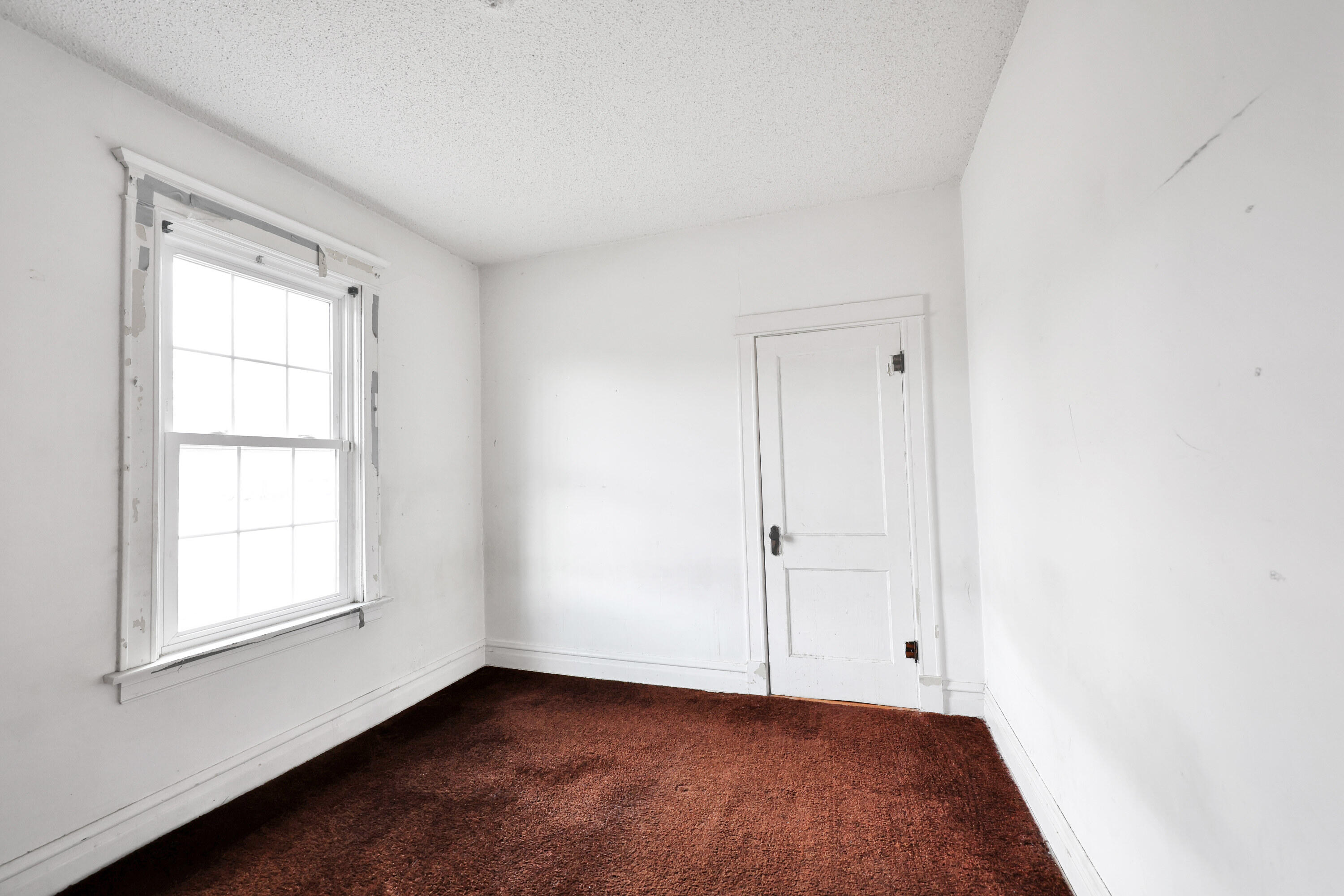 112 South Indiana Street Hobart, IN 46342 - Photo 13 of 25 an empty room with wooden floor and window
