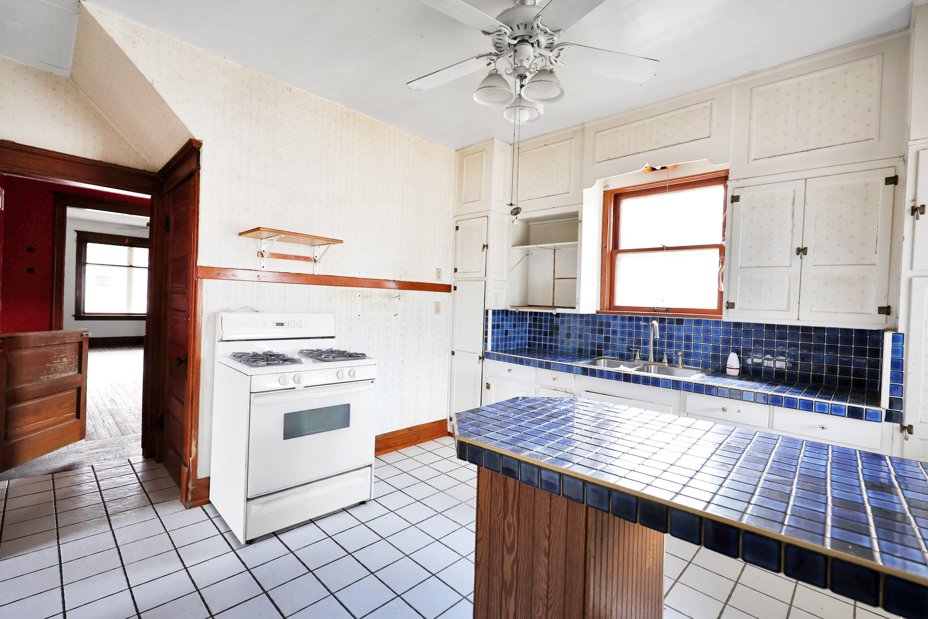 112 South Indiana Street Hobart, IN 46342 - Photo 16 of 25 a kitchen with granite countertop white cabinets and white appliances