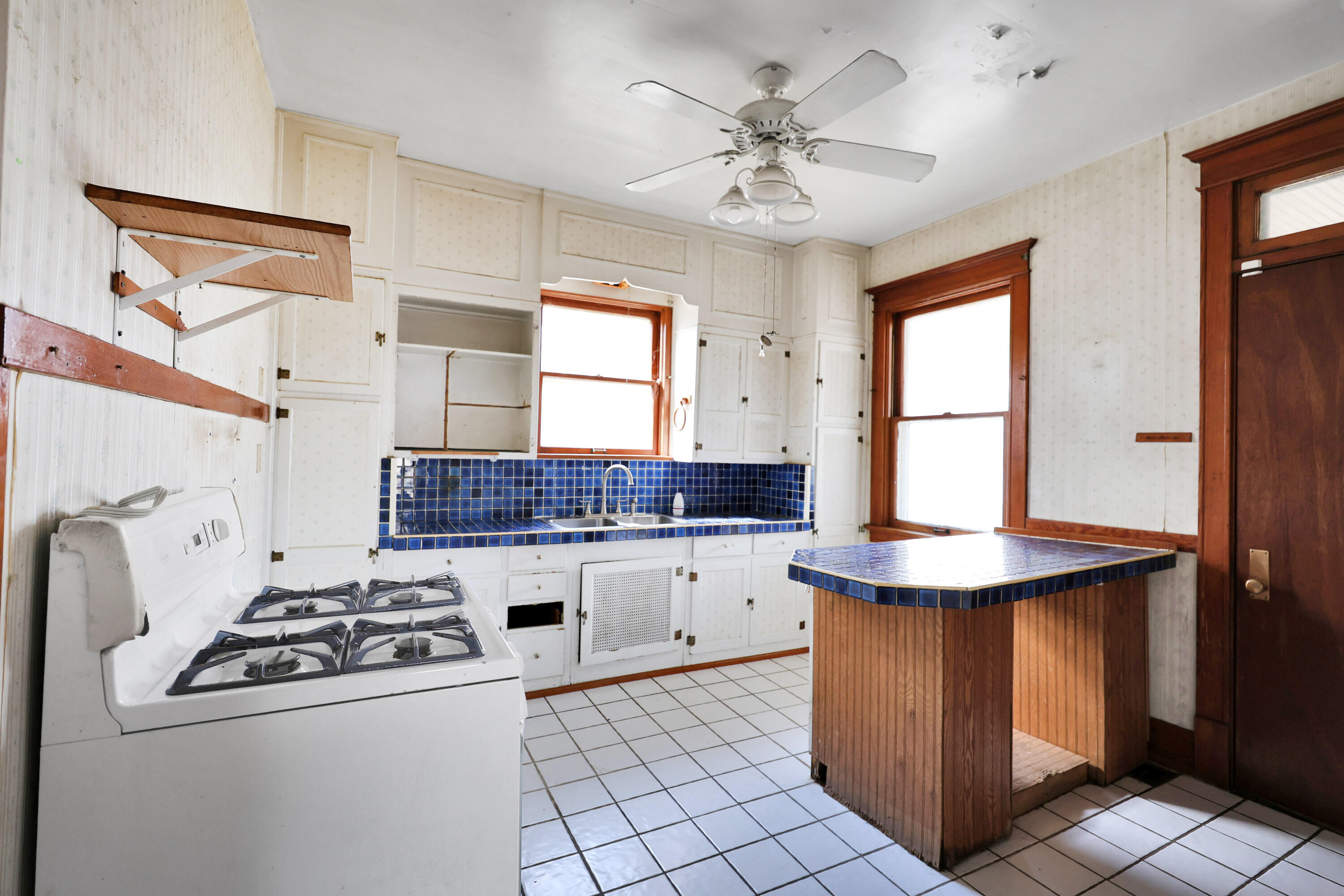 112 South Indiana Street Hobart, IN 46342 - Photo 17 of 25 a kitchen with a stove a sink and a refrigerator