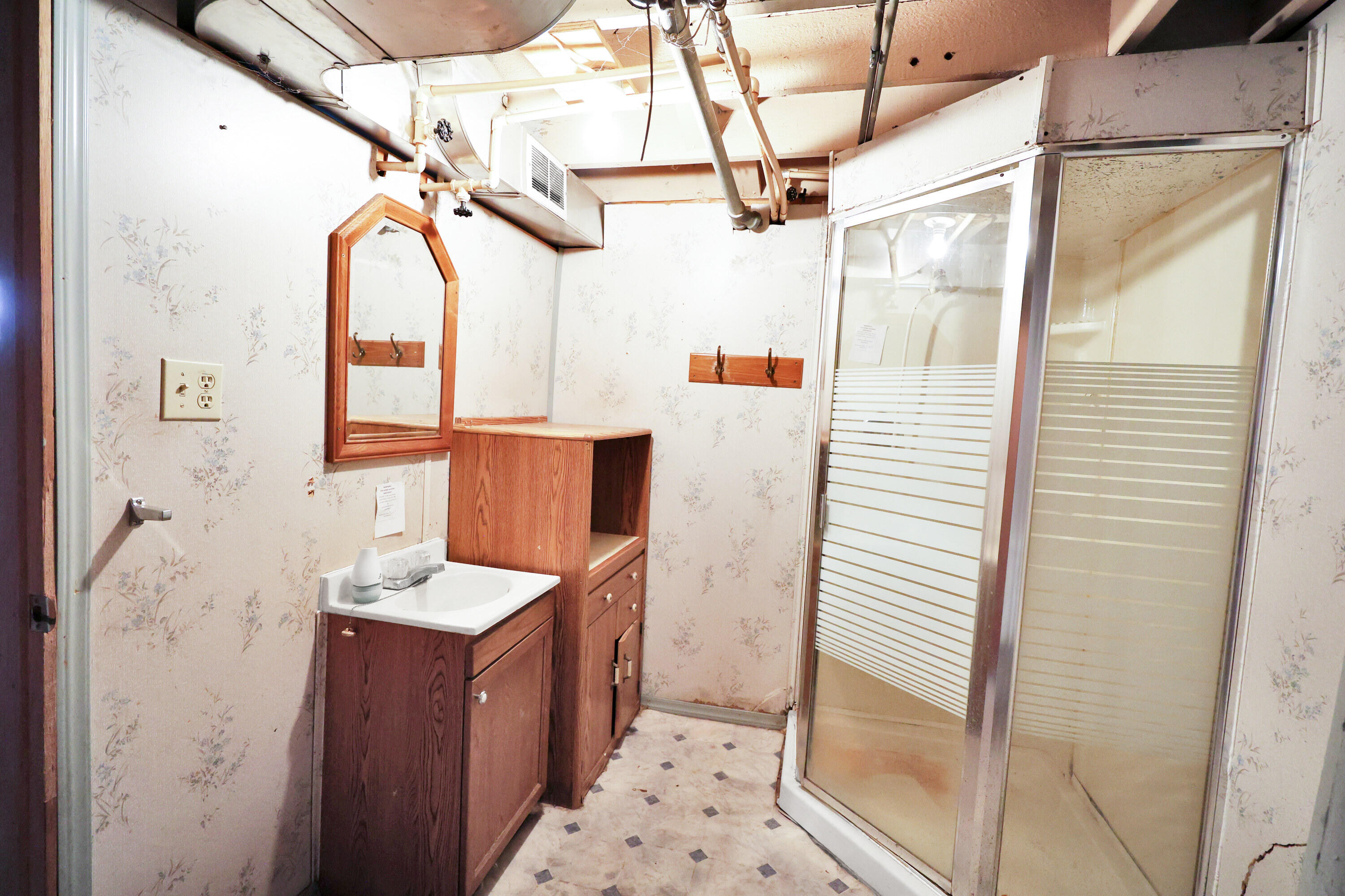 112 South Indiana Street Hobart, IN 46342 - Photo 24 of 25 a bathroom with a sink a mirror and shower