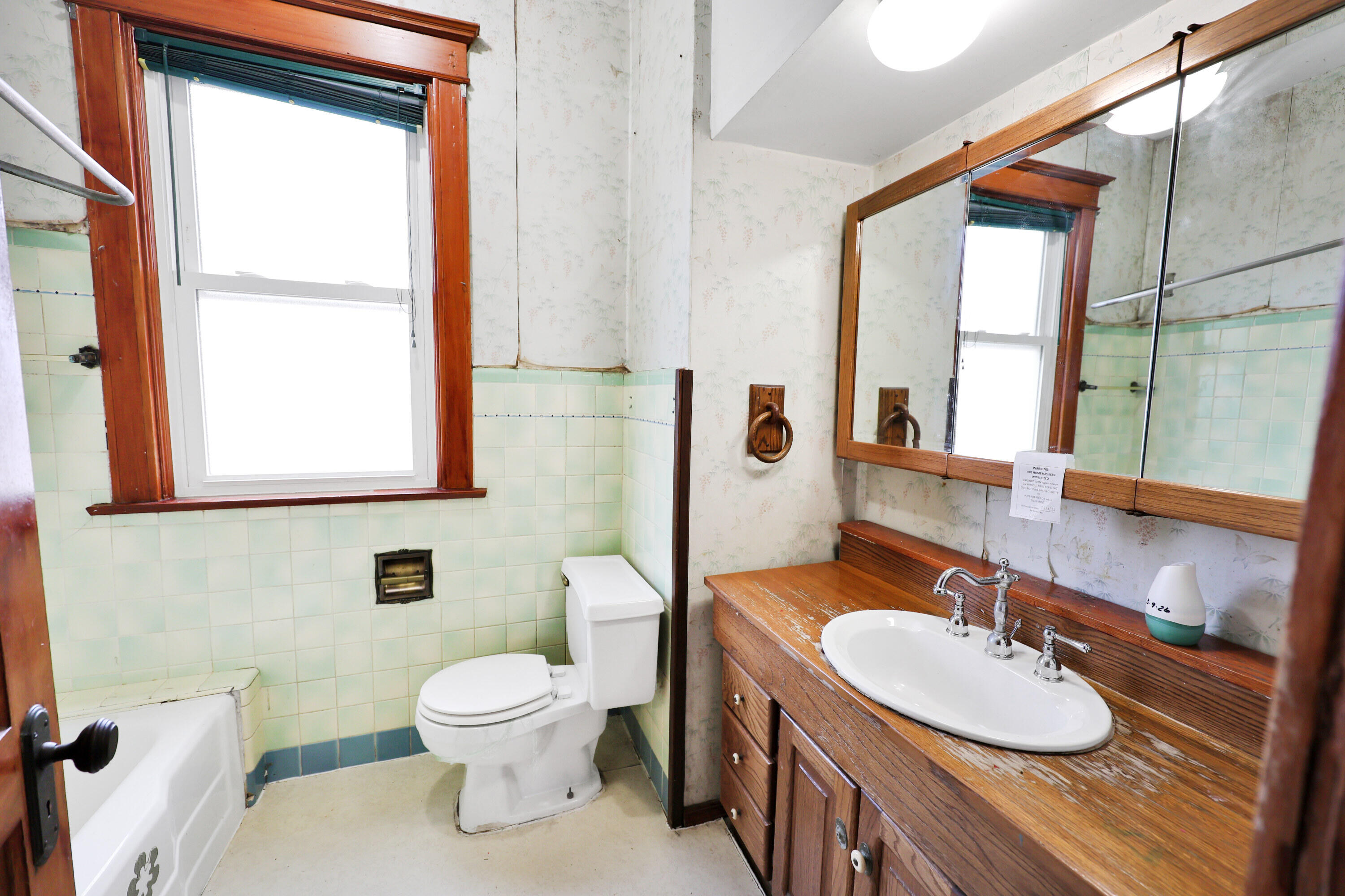 112 South Indiana Street Hobart, IN 46342 - Photo 10 of 25 a bathroom with a toilet a sink and a mirror