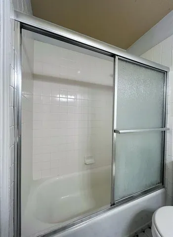 a bathroom with a glass shower door