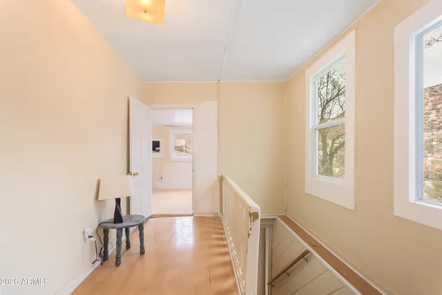 a view of an empty room with closet and a window