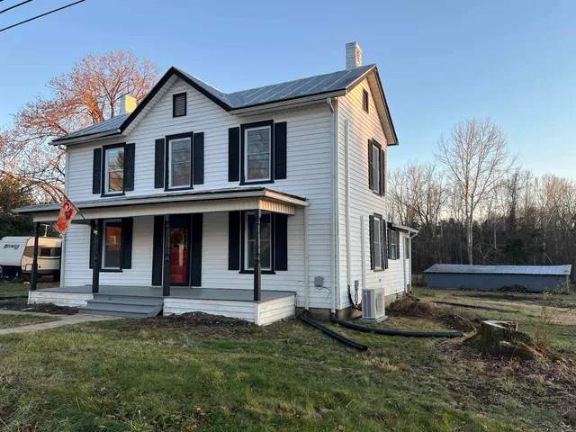 a view of a white house with a yard