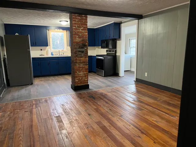 a kitchen with stainless steel appliances granite countertop a refrigerator and a stove top oven